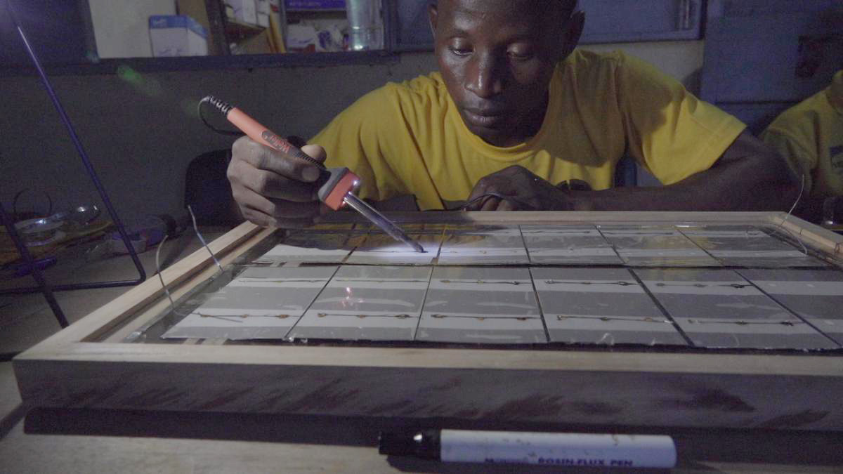 man working on solar panel